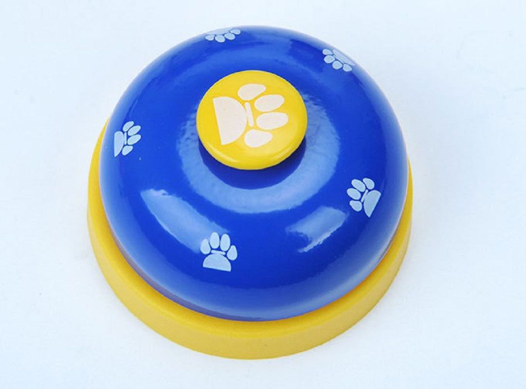 Pet training bell clicker with paw print design and non-skid base for dog and cat communication.